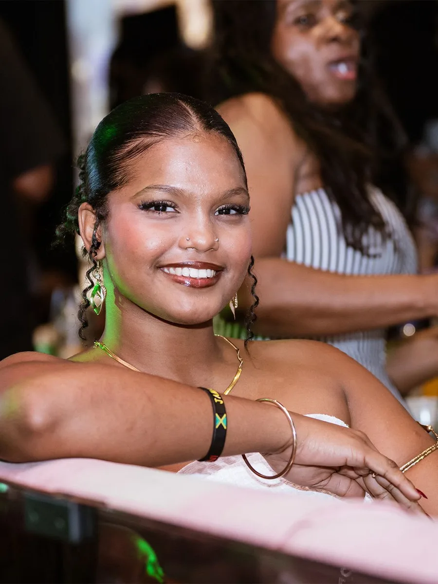 A smiling guest enjoying the lively atmosphere at a Soul Food Sunday event